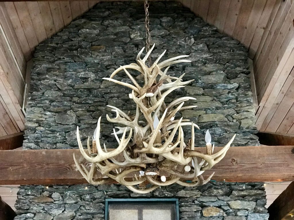 lodge chandelier in front of fireplace